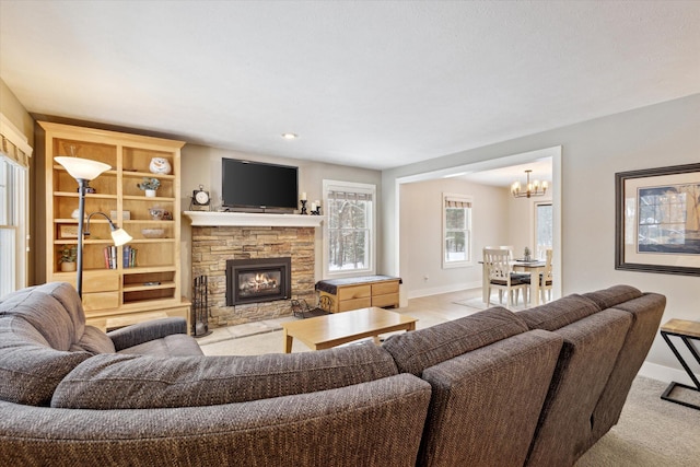 living room with a notable chandelier, light colored carpet, and a fireplace