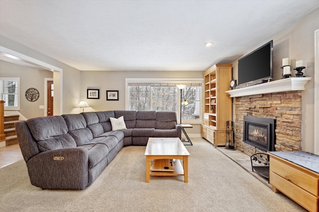 carpeted living room with a fireplace