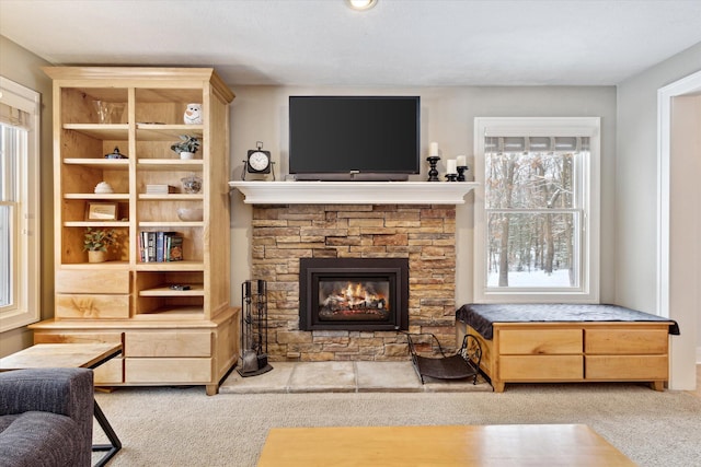 carpeted living room with a fireplace