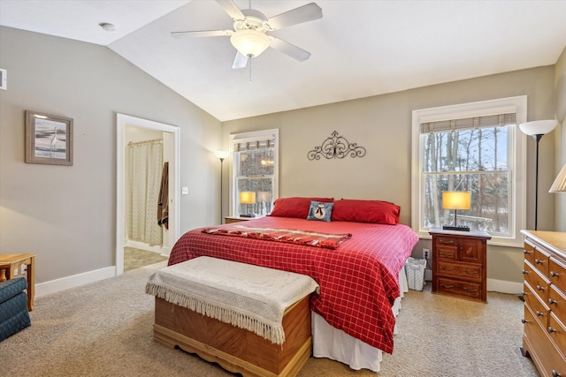 carpeted bedroom featuring ensuite bath, ceiling fan, and lofted ceiling