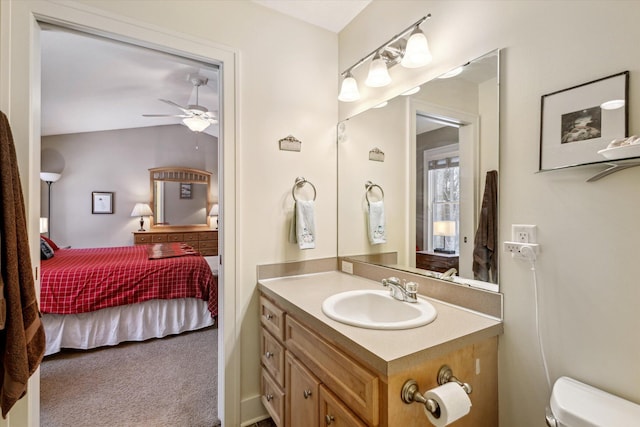 bathroom featuring ceiling fan, vanity, and toilet