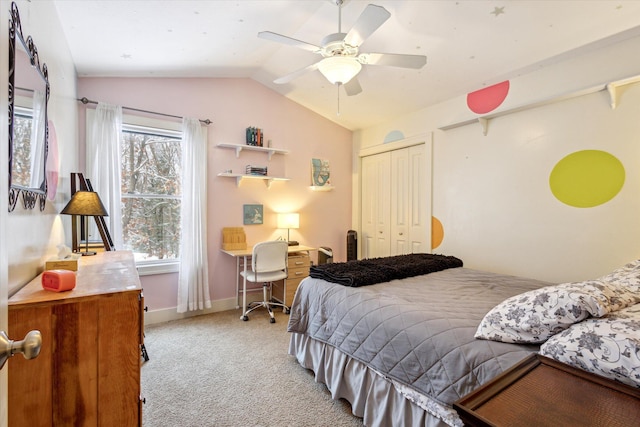 bedroom with ceiling fan, lofted ceiling, multiple windows, and a closet