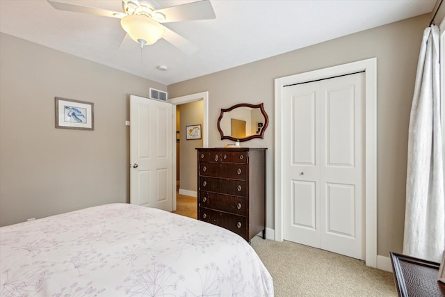 bedroom with light carpet, a closet, and ceiling fan