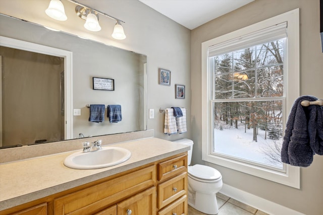 bathroom featuring toilet, vanity, and tile patterned floors