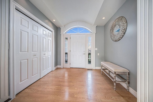 foyer entrance featuring light wood-type flooring and lofted ceiling