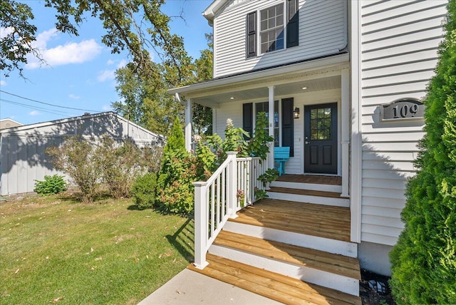 doorway to property featuring a lawn