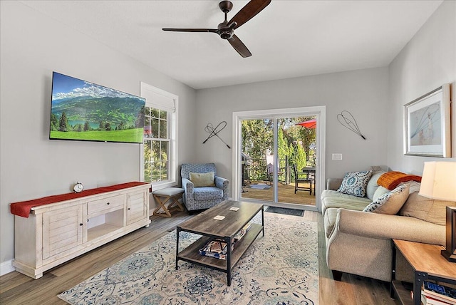 living room featuring wood-type flooring and ceiling fan