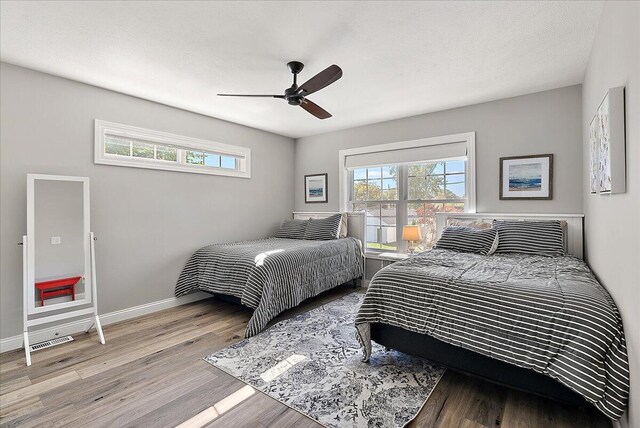 bedroom with ceiling fan and hardwood / wood-style floors