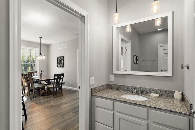 bathroom with vanity and hardwood / wood-style flooring