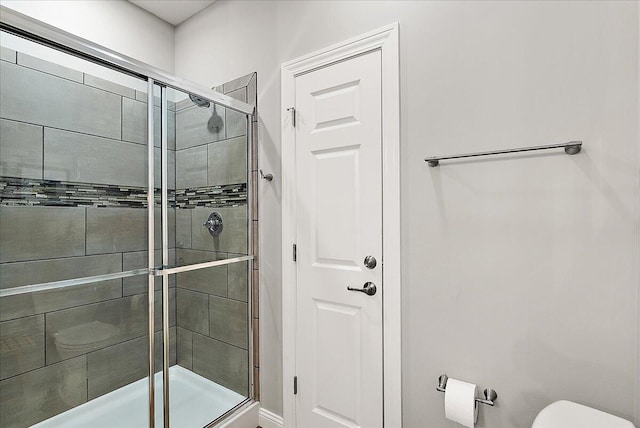 bathroom featuring toilet and walk in shower