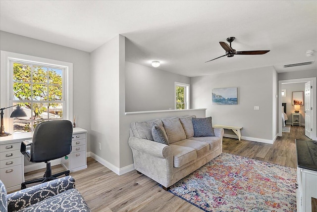 home office featuring light hardwood / wood-style floors and ceiling fan