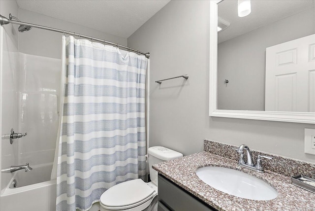 full bathroom featuring vanity, toilet, shower / bathtub combination with curtain, and a textured ceiling