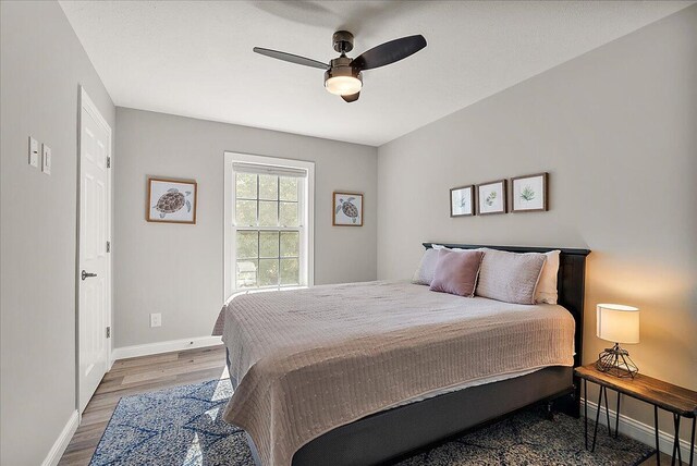 bedroom with ceiling fan and wood-type flooring