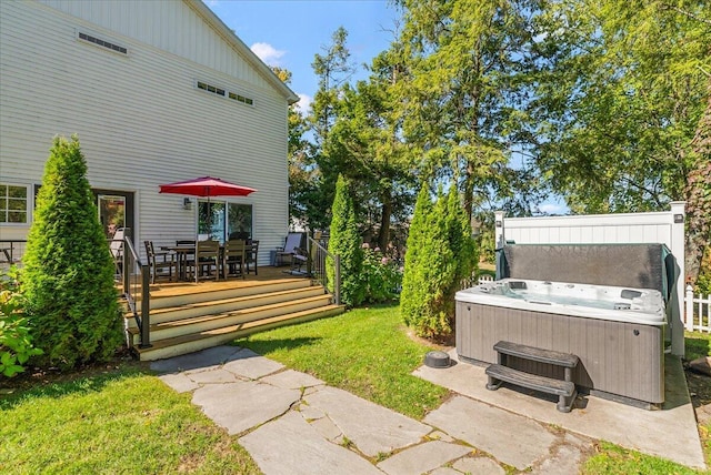 view of yard with a wooden deck and a hot tub