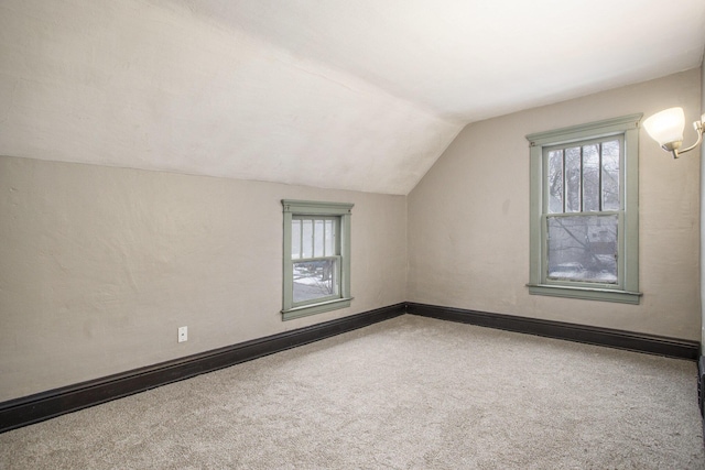 bonus room with lofted ceiling and carpet floors