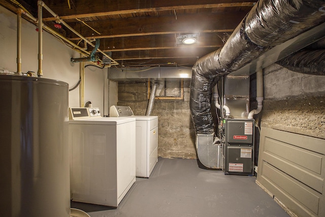 basement featuring heating unit, gas water heater, and washing machine and clothes dryer