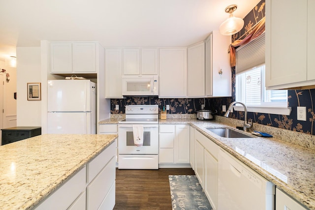 kitchen with white cabinets, white appliances, and sink