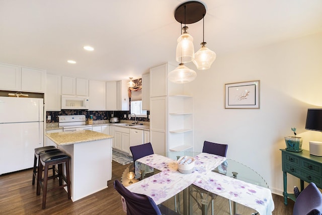 dining room with dark wood-type flooring and sink