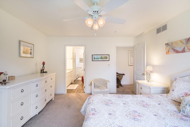 carpeted bedroom featuring ensuite bath and ceiling fan