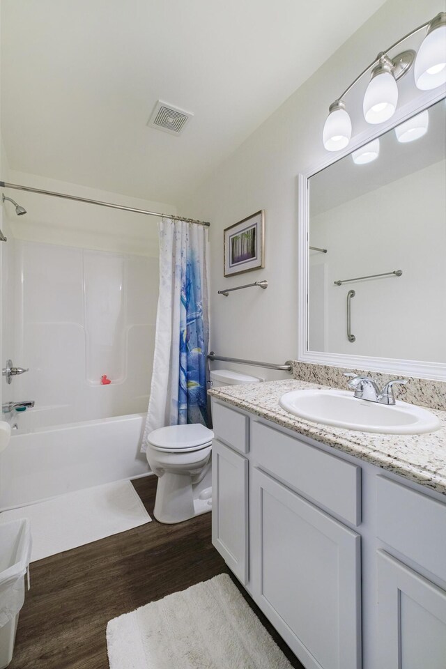 full bathroom with wood-type flooring, vanity, toilet, and shower / bath combination with curtain