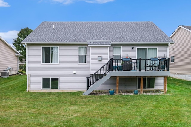 rear view of house featuring a lawn, a wooden deck, and central air condition unit