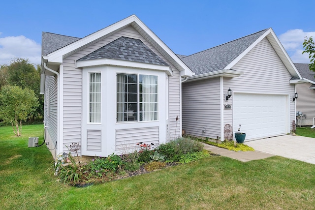 view of front of property with a front yard and a garage