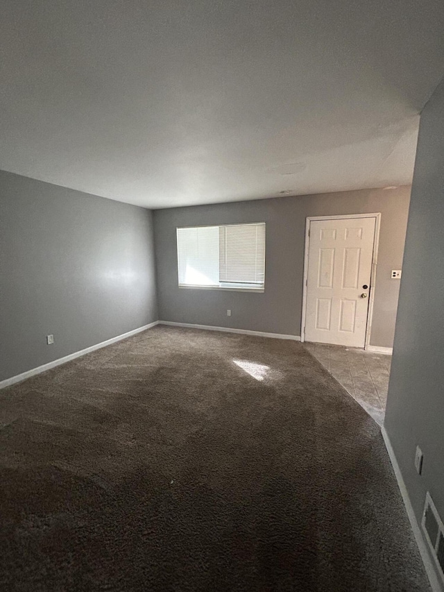 unfurnished room featuring light carpet