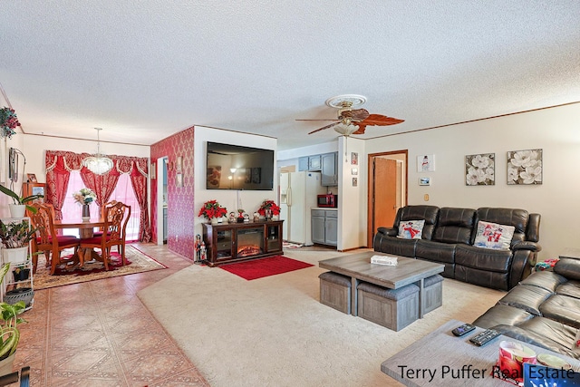 living room with ceiling fan and a textured ceiling