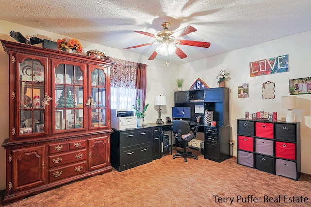 carpeted office space with ceiling fan and a textured ceiling