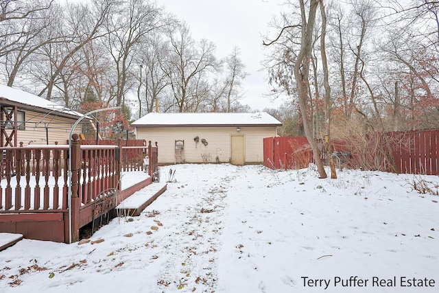 yard covered in snow featuring a deck