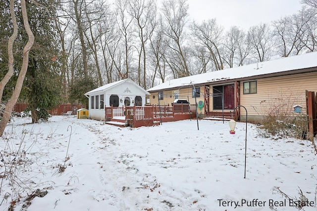 snow covered property featuring a wooden deck