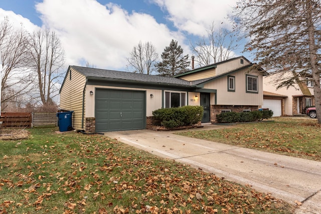 split level home featuring a front lawn and a garage