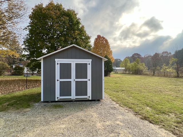 view of outbuilding featuring a yard