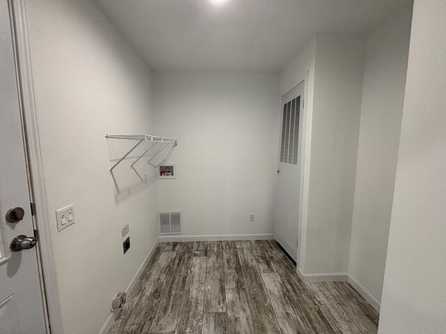 clothes washing area featuring washer hookup, hardwood / wood-style flooring, and electric dryer hookup