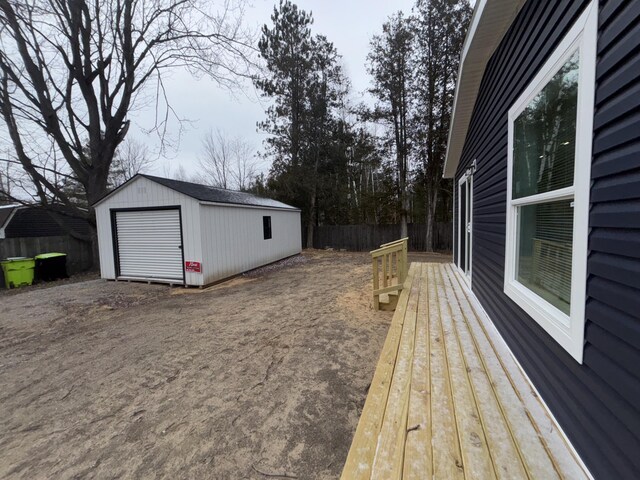 view of yard featuring a garage and an outdoor structure