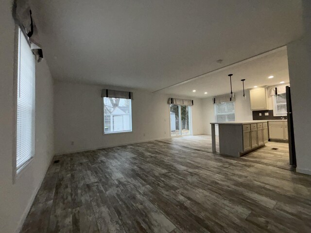 unfurnished living room featuring wood-type flooring