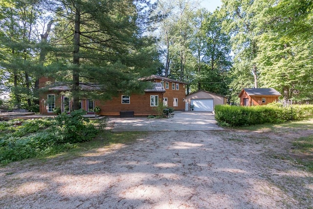 view of front facade with a garage and an outbuilding