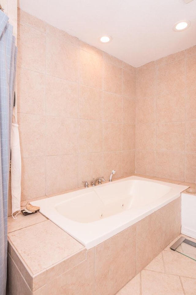 bathroom with tile patterned floors, tile walls, and tiled bath