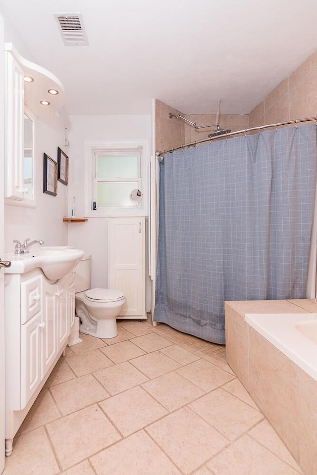 bathroom featuring vanity, toilet, and plenty of natural light