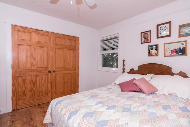 bedroom with light wood-type flooring, a closet, and ceiling fan