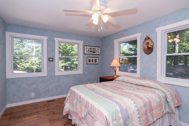 bedroom featuring ceiling fan and dark hardwood / wood-style flooring