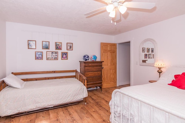 bedroom with ceiling fan and light hardwood / wood-style floors