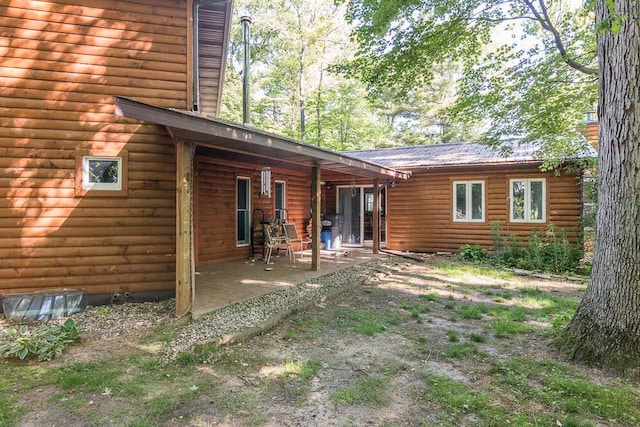 rear view of property featuring a patio area