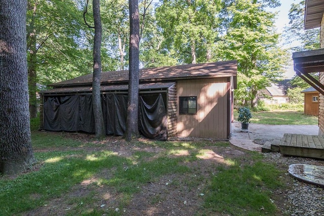 view of outbuilding with a yard