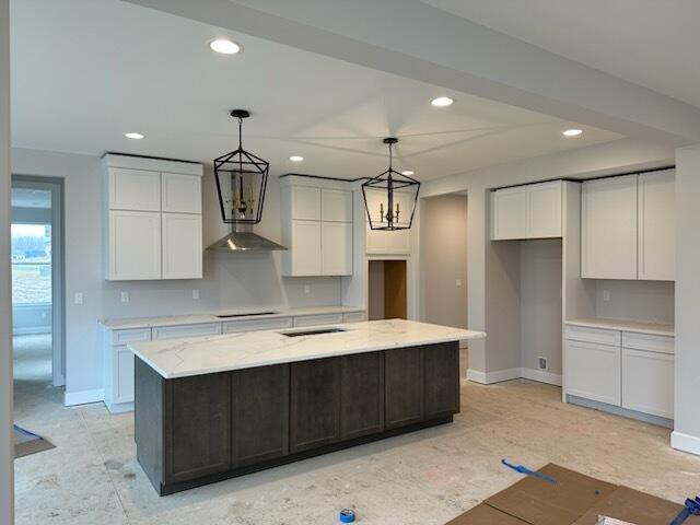 kitchen with cooktop, baseboards, white cabinetry, and recessed lighting