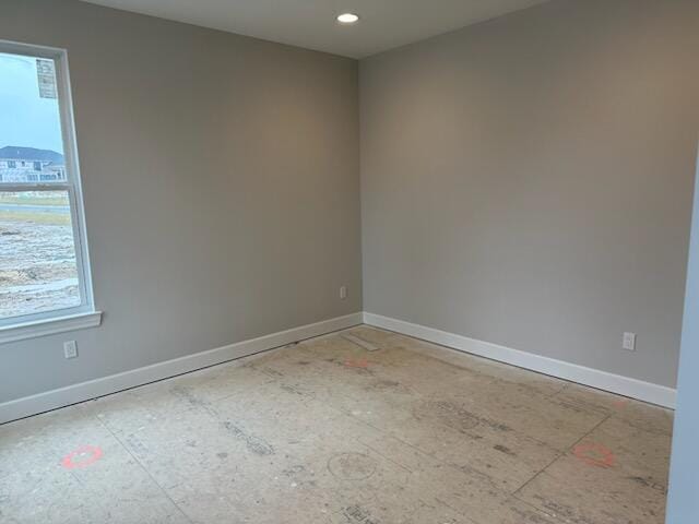 spare room featuring baseboards and recessed lighting