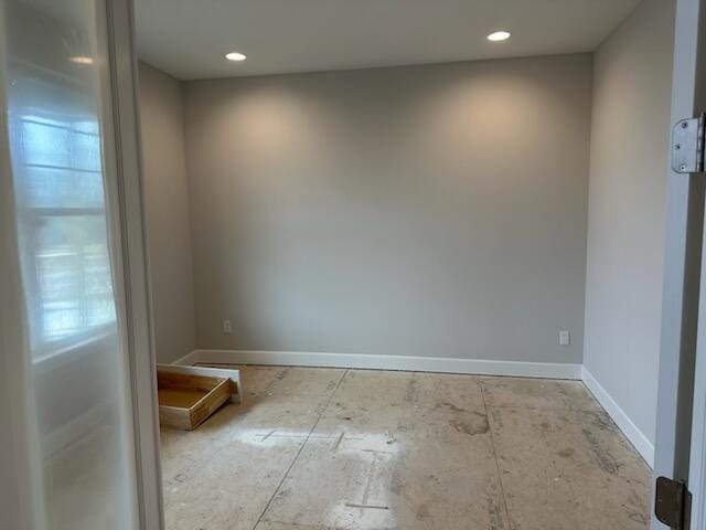 unfurnished room featuring recessed lighting and baseboards