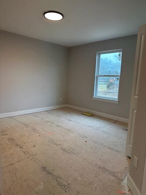 spare room featuring baseboards