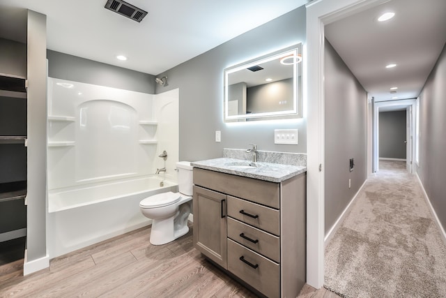 full bathroom featuring shower / bathing tub combination, vanity, wood-type flooring, and toilet