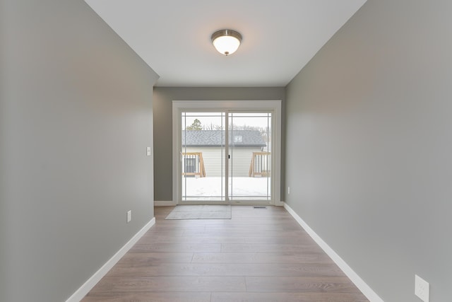 spare room featuring light wood-type flooring